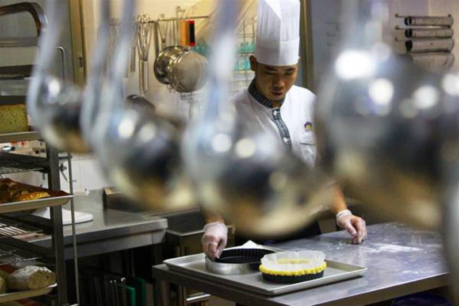 Al Ahsa Grand Serviced Apartment Al-Hofuf Exterior photo A cook working in a commercial kitchen